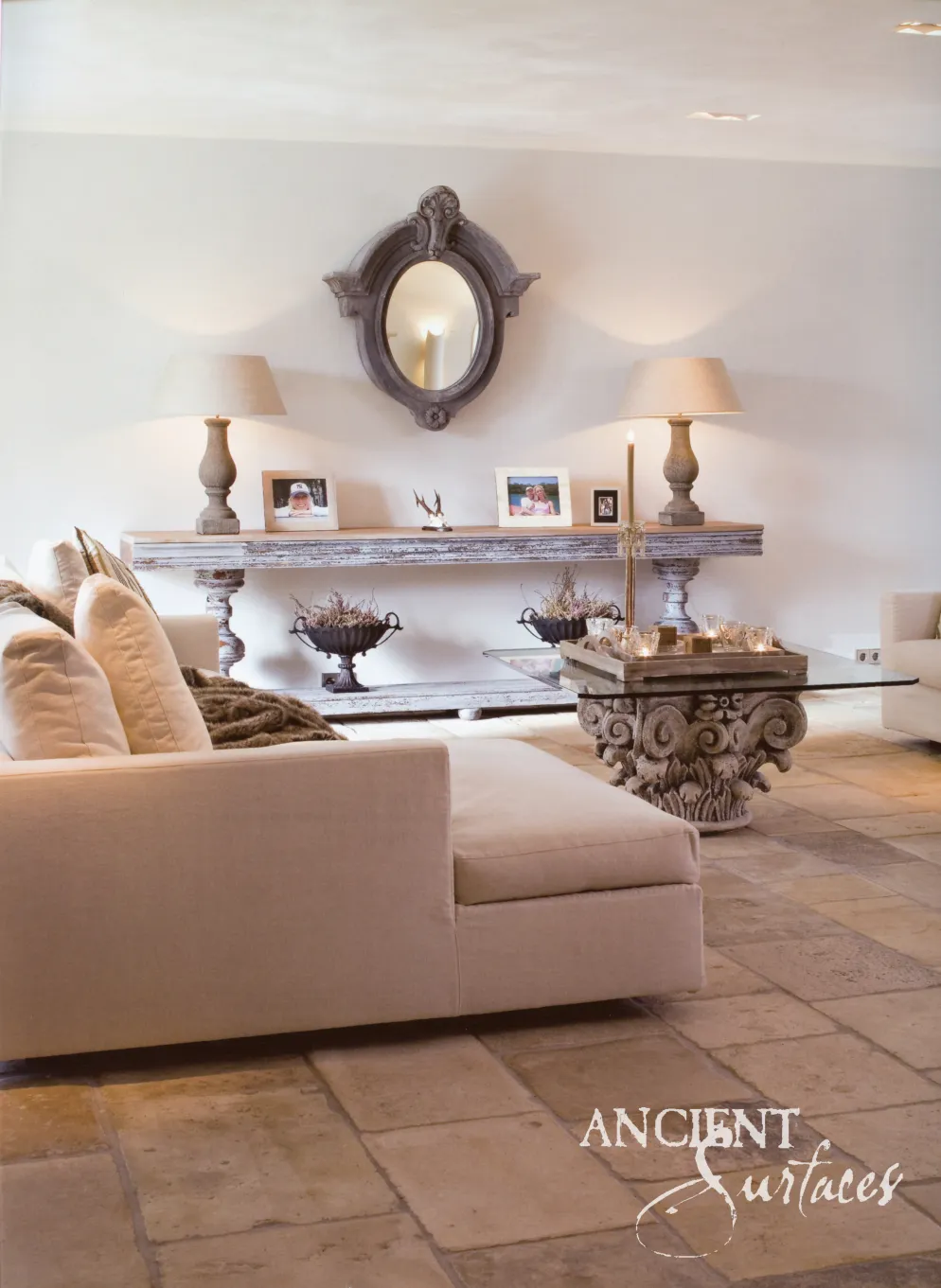 Living room with antique reclaimed limestone flagstone flooring and a carved stone capital table