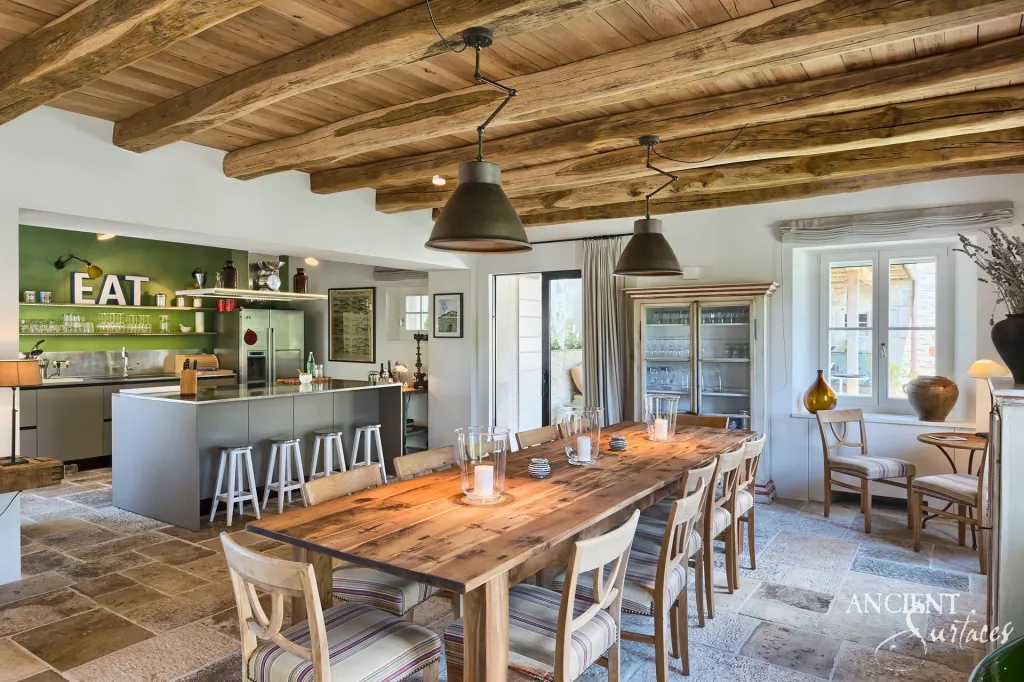 Farmhouse kitchen and dining room with reclaimed limestone flagstone flooring and timber beams